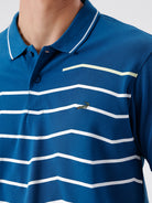 Man wearing a green iceberg green chest print slim fit polo t shirt on a light gray background