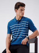 Man wearing a green iceberg green chest print slim fit polo t shirt on a light gray background