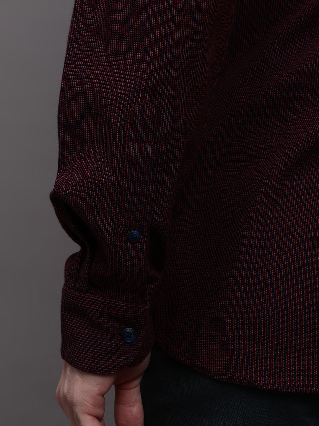 Man wearing a red red striped full sleeve 100% cotton shirt on a light gray background