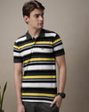 Man wearing a grey grey yellow striped polo t shirt with casual styling on a gray background