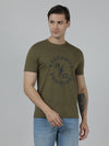 Man wearing a green typography printed single jersey cotton t shirt olive green on a light gray background
