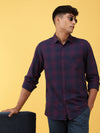 Man wearing a pink dark pink checked full sleeve 100% cotton shirt on a light gray background