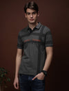 Man wearing a green kombu green printed casual polo t shirt on a light gray background
