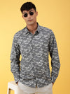 Man wearing a grey grey printed full sleeve shirt on a light gray background