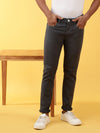 Man wearing a grey cotton solid grey jeans on a light gray background