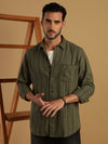 Man wearing a green green striped full sleeve 100% cotton shirt with casual styling on a gray background