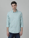Man wearing a blue aqua blue checked full sleeve 100% cotton shirt with casual styling on a gray background
