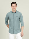 Man wearing a blue deep lake blue checked full sleeve 100% cotton shirt on a light gray background