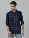 Man wearing a navy navy checked casual full sleeve shirt on a light gray background