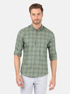 Man wearing a green green checked full sleeve casual shirt with casual styling on a gray background