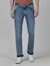 Man wearing a blue light blue solid mid rise casual slim fit jean on a light gray background