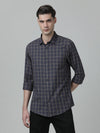 Man wearing a grey grey checked casual full sleeve 100% cotton shirt on a light gray background