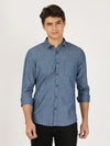 Man wearing a blue light blue solid full sleeve 100% cotton casual shirt on a light gray background