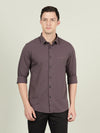 Man wearing a brown brown sugar solid full sleeve 100% cotton casual shirt on a light gray background