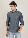 Man wearing a grey grey solid full sleeve 100% cotton casual shirt on a light gray background