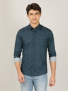 Man wearing a blue teal blue printed full sleeve 100% cotton casual shirt on a light gray background