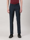 Man wearing a navy navy casual solid slim fit trouser with casual styling on a gray background