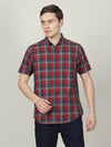 Man wearing a navy indigo navy checked half sleeve 100% cotton shirt with casual styling on a gray background