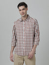 Man wearing a red brick red checked full sleeve 100% cotton shirt on a light gray background