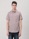 Man wearing a maroon checked half sleeve 100% cotton casual shirt on a light gray background