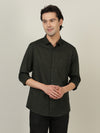 Man wearing a green dark olive green solid full sleeve 100% cotton shirt with casual styling on a gray background