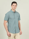 Man wearing a blue deep lake blue checked half sleeve 100% cotton shirt on a light gray background